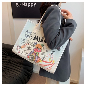 Detail of a large white canvas tote bag featuring vibrant colorful graffiti and cute bear art