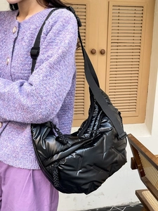 Quilted black puffer crescent bag for women with wide adjustable shoulder strap