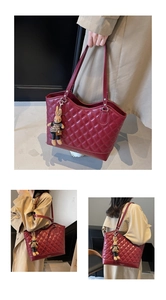 Detail of red quilted bucket bag with rabbit charm and Fashion Bag embossed logo