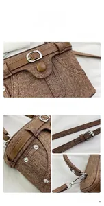 Detailed close-up of brown textured fabric handbag with silver rivets and leather straps