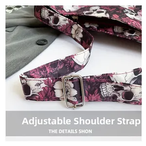 Detail of adjustable shoulder strap with gothic skull and purple floral print on canvas bag