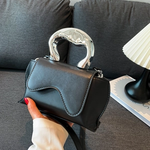 Minimalist black matte leather bag with artistic silver twisted handle and wave flap