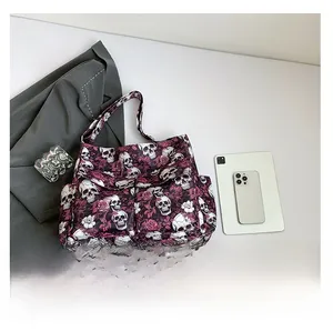 Detail view of large gothic canvas tote bag with purple skull and flower floral prints