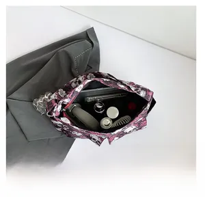 Macro shot of large capacity canvas bag interior showing water bottle and headphone storage