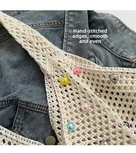 Detailed macro view of beige crochet bag with colorful beads and textured hand-stitched edges