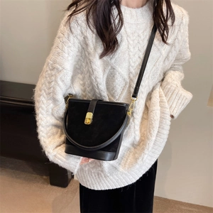 Matte black bucket bag for women with gold hardware and elegant vintage leather stitching