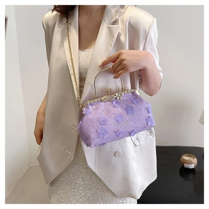 Detail of light purple floral embroidery evening bag with gold metal handle and chain