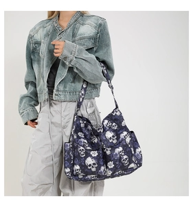 Detail of gothic skull and purple rose print canvas bag with functional zipper pockets