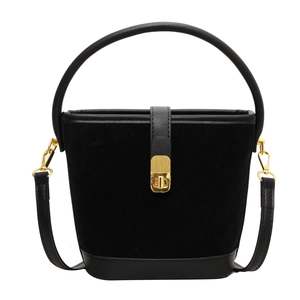 Minimalist black suede bucket bag with leather trim and gold metal rotating lock