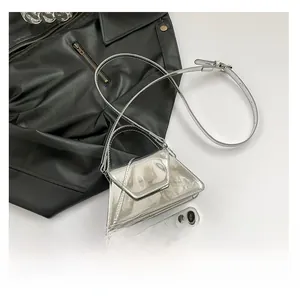 Detailed view of mini triangular metallic silver bag showing glossy reflective texture