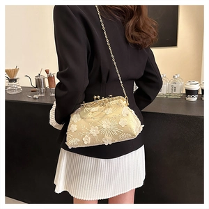 Detail of champagne gold satin evening bag with 3D floral embroidery and gold chain