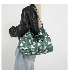 Detail of dark green canvas tote featuring skull and rose prints with side pockets