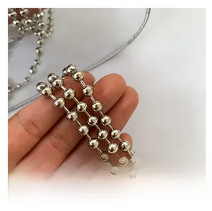 Detailed view of glossy silver metal bead chain strap for modern women's handbags