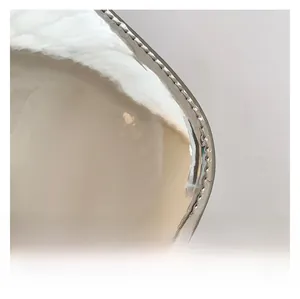 Macro view of silver patent leather material with neat stitching and reflective finish