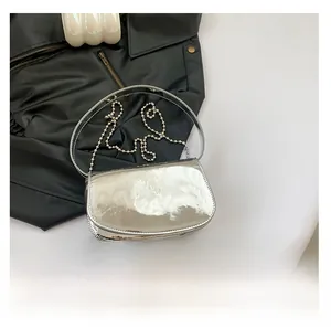 Silver patent leather handbag size comparison with phone and metal bead chain strap