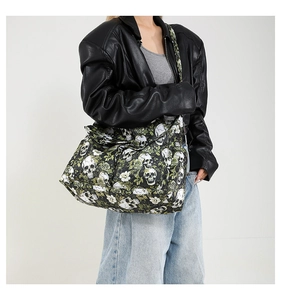 Detail of large canvas tote bag with white skull and green rose gothic print