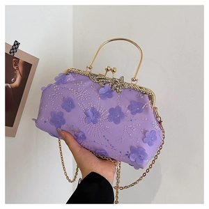 Detail of lavender evening bag with 3D floral embroidery and gold metal clasp