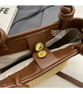 Detail showing convenient magnetic cylinder buckle closure on woven straw bucket bag