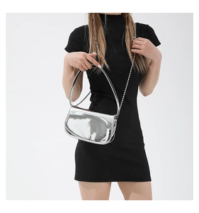Close-up of metallic silver mirror finish shoulder bag with trendy Y2K metal bead chain