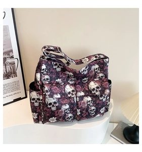 Close-up of gothic canvas tote bag with skull and rose print and functional pockets