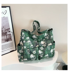 Detail of gothic skull and green rose print on large canvas tote bag with side pockets