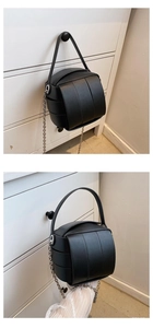 Detail der schwarzen geflochtenen Kugeltasche mit Silberkette und strukturierter PU-Leder-Optik
