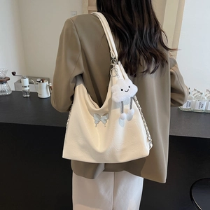 White hobo shoulder bag with blue butterfly detail and plush charm on chain strap