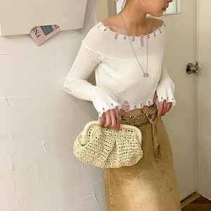 Chic mini straw woven shoulder bag for beach fashion, styled with knit top and denim skirt