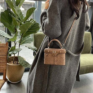 Brown box-shaped crossbody bag with denim pocket stitching and top handle