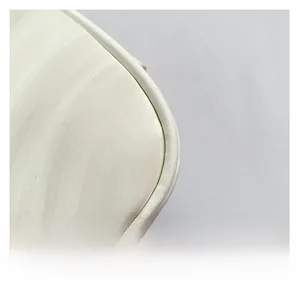 Close-up of premium cream white faux leather texture and precise stitching on the handbag