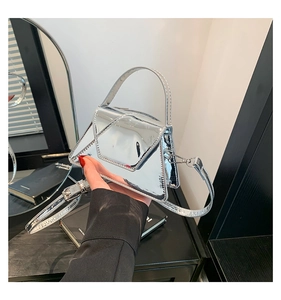 Detail of silver mirror geometric handbag with polished metallic finish and top handle