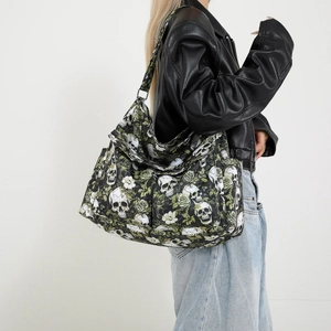 Hobo canvas shoulder bag featuring green floral and skull print for casual street style
