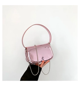 Close-up of pink patent leather shoulder bag with silver bead chain and glossy mirror finish
