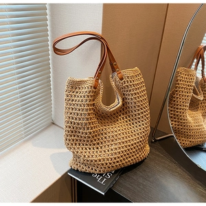 Detail of hand-woven mesh tote bag with durable faux leather handles and rivets