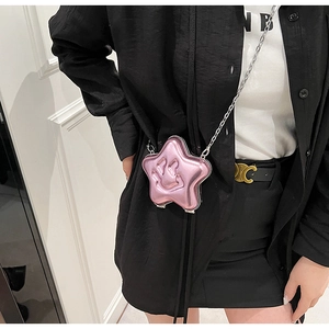 Pink star-shaped crossbody bag with smiley face detail and silver chain strap