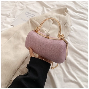 Detailed view of pink glitter evening clutch with golden handle and diamond clasp