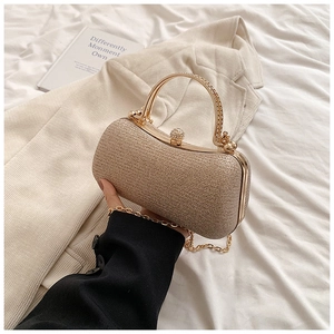 Detail of champagne gold sequin evening bag with crystal clasp and metal handle