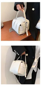 Nahaufnahme der weißen geflochtenen Eimertasche mit abnehmbarer silberner Kette