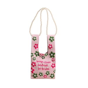 Pink knit bucket bag with floral patterns, white pearl strap and elegant pearl accents