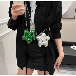 Detail of metallic silver and green star-shaped chain bags with embossed smiley face