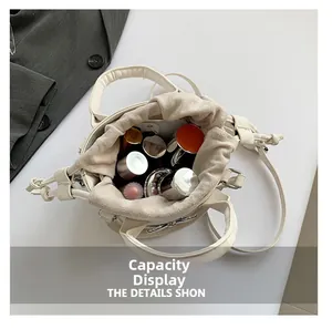 Top view showing large storage capacity of cream bucket bag with cosmetics inside