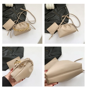 Detail view of beige drawstring bucket bag with gold chain and lychee texture grain