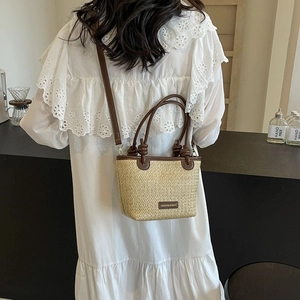 Large capacity straw shoulder bag with brown leather trim and knotted handles