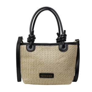 Large woven straw tote bag with black leather handles and fashion label for women