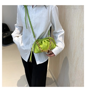 Green pleated cloud bag with chunky gold chain detail and textured litchi pattern