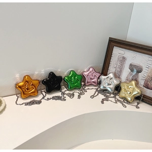 Selection of colorful star-shaped mini crossbody bags with metallic finish and smiley face