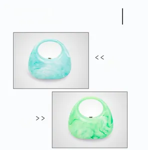 Detail view of light blue and green marble acrylic crescent handbags with round handles