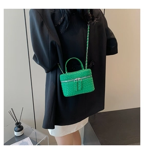Dettaglio della mini borsa vanity verde acceso con catena argento e doppia cerniera
