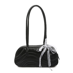 Fashionable black wavy textured barrel handbag with a white lace bow detail