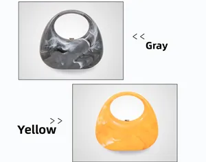 Detail view of acrylic marble pattern clutch bags in grey and yellow with crescent handles